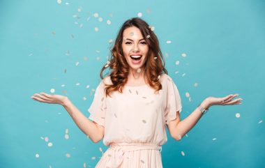 Portrait,of,a,cheerful,beautiful,girl,wearing,dress,standing,standing