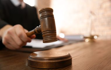 Judge,with,gavel,at,table,in,courtroom,,closeup.,law,and