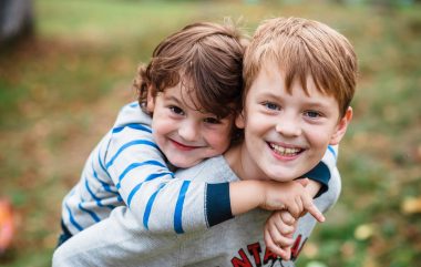 Two,Happy,Boys,,Happy,Brothers,Who,Are,Smiling,Happily,Together.