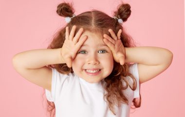 Portrait,of,surprised,cute,little,toddler,girl,child,over,pink