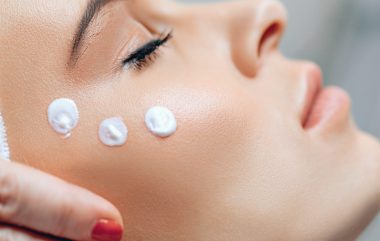 Close,Up,Woman's,Face,With,Cream,Applied,To,Cheekbones,And