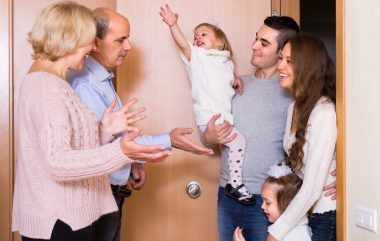 Happy,smiling,aged,couple,meeting,kids,and,grand,children,at