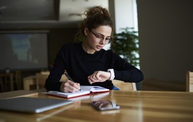 Talented,Female,Writer,In,Stylish,Eyeglasses,Noting,Some,Information,In