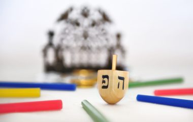 Photo,Of,A,Dreidel,(spinning,Top),,A,Bronze,Menorah,,And