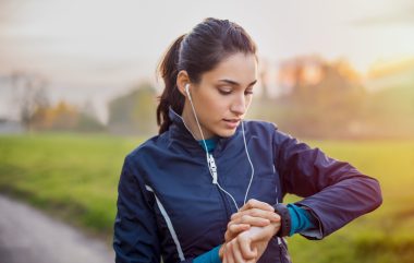 Young,athlete,listening,to,music,during,workout,at,park,and