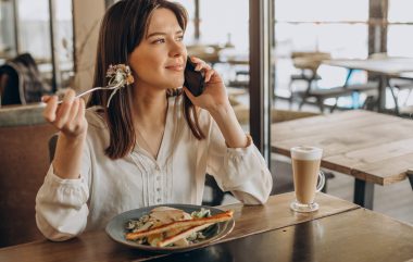 Woman having lunch in a cafe, eating salad
