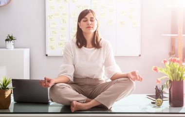 Businesswoman Meditating In Office