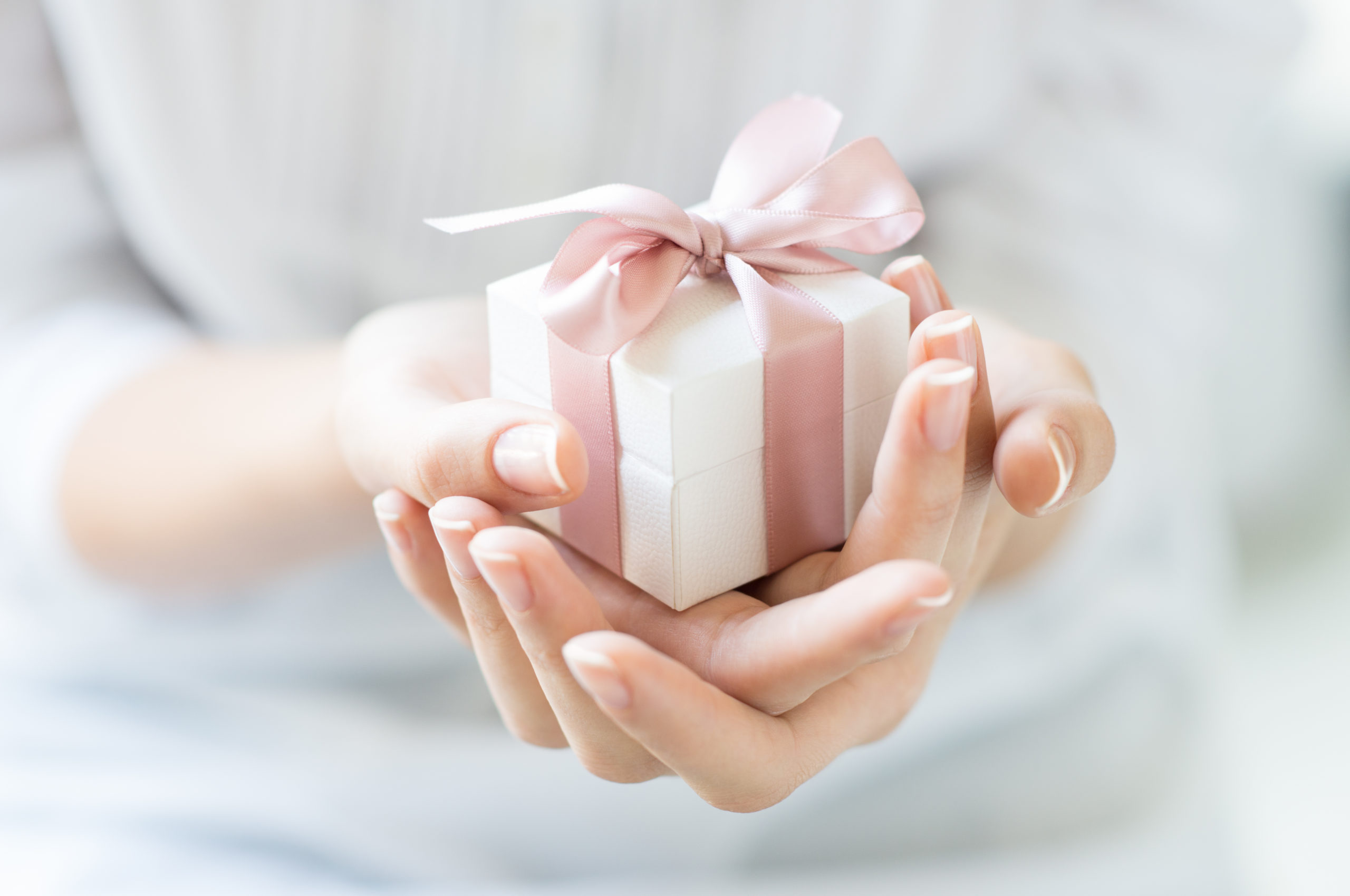 Close,up,shot,of,female,hands,holding,a,small,gift