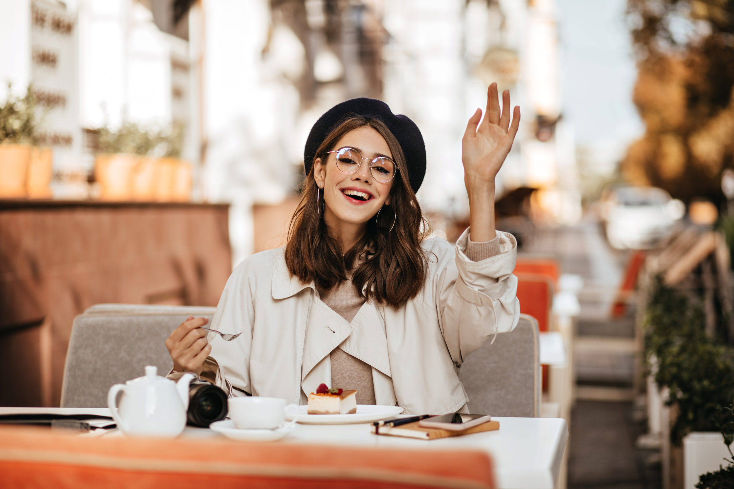 Joyful Young Brunette With Beret, Beige Trench Coat And Stylish Glasses, Sitting At City Cafe Terra