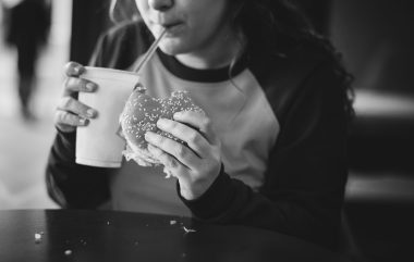 Close Up Of Teenage Girl Eating Hamburger