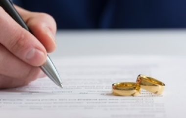 Hands,of,wife,,husband,signing,decree,of,divorce,,dissolution,,canceling