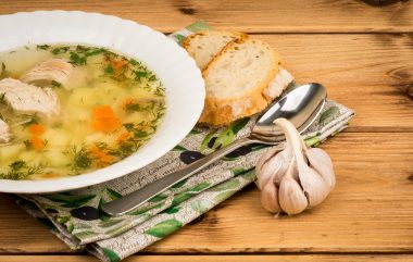 Chicken,soup,with,a,bread,and,garlic,on,the,wooden