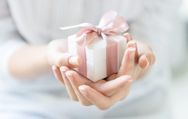 Close,up,shot,of,female,hands,holding,a,small,gift