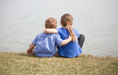 Young,Sibling,Boy,And,Girl,Looking,At,The,Lake,Holding