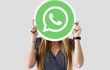 Woman showing a WhatsApp Messenger icon