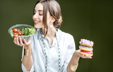 Nutritionist With Donuts And Healthy Salad